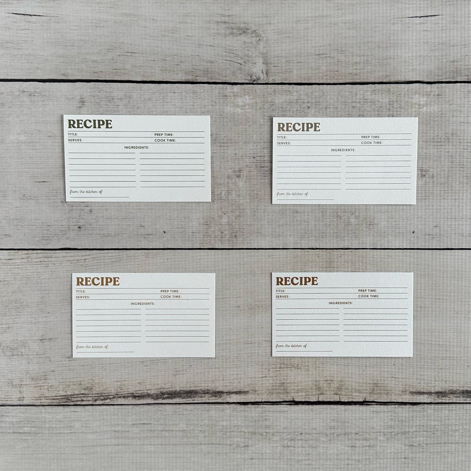 Four white recipe cards on a wooden surface