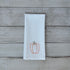 White tea towel with embroidered orange bell pepper design on a wooden surface