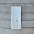 White tea towel with embroidered yellow bell pepper design on a wooden surface