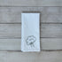 White tea towel with embroidered broccoli design on a wooden surface